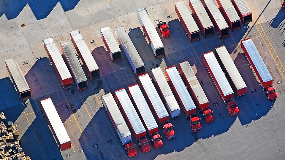 Aerial view of a fleet of parked heavy-duty trucks 
