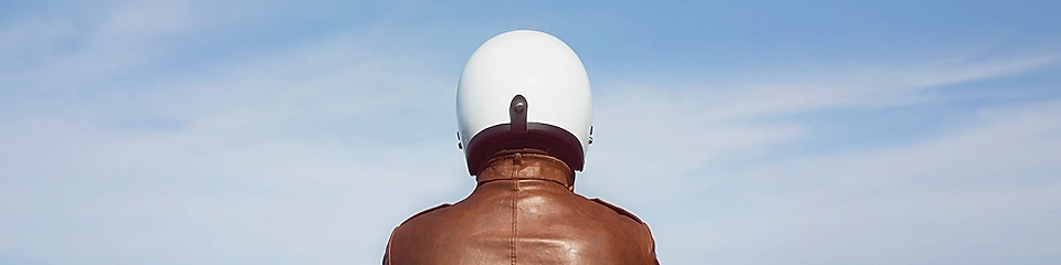 person in brown jacket and white helmet