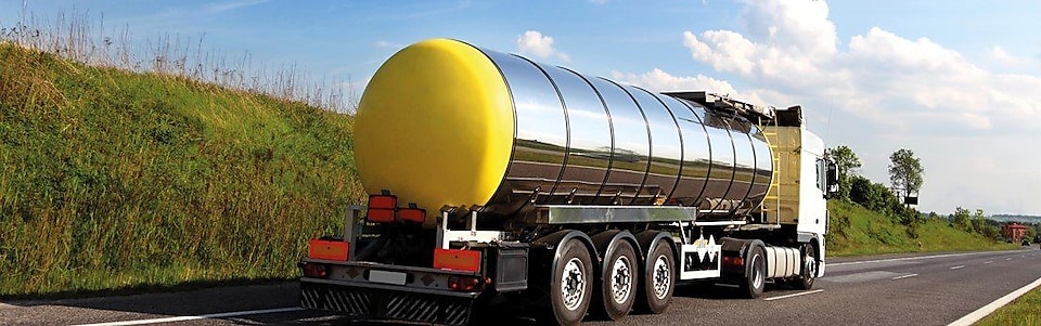 A picture containing outdoor, sky, road, grass and Liquefied Natural Gas tanker.