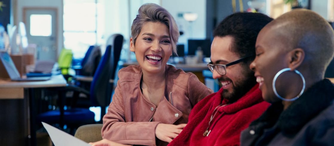 Laughing creative business people working in office