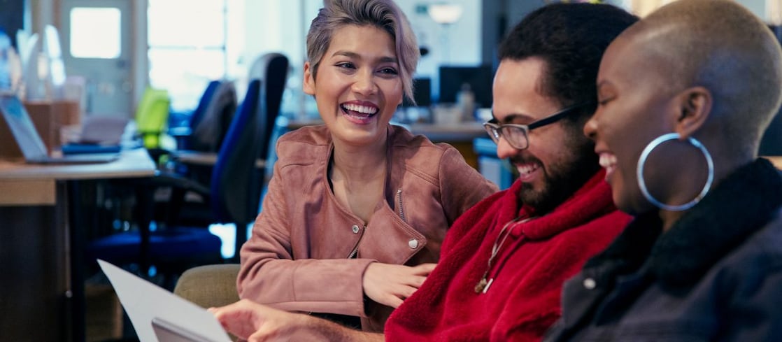 Laughing creative business people working in office