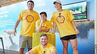Four Shell volunteers in yellow shirts posing.