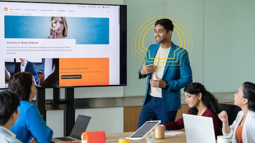 A male colleague making a presentation about Data Science to his team members.