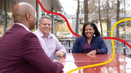 Three people chatting and smiling