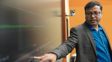 An employee making a presentation on a large screen.