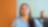 An Indian woman in a blue shirt smiles while looking up, with pecten energy lines overlay. Another person is in the blurred background.