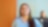 An Indian woman in a blue shirt smiles while looking up, with pecten energy lines overlay. Another person is in the blurred background.