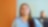 An Indian woman in a blue shirt smiles while looking up, with pecten energy lines overlay. Another person is in the blurred background.