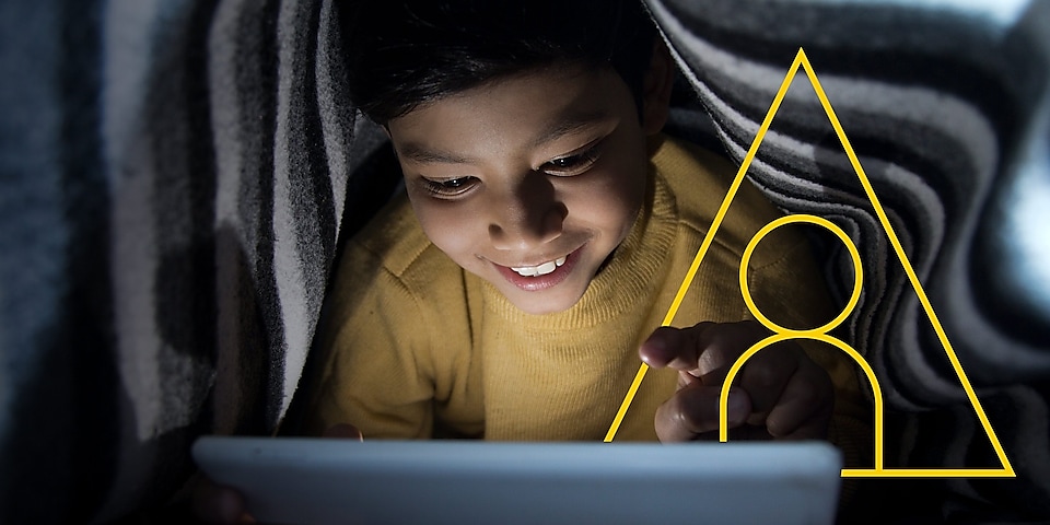 Photo of young boy looking at a tablet with an outline of the Powering lives graph