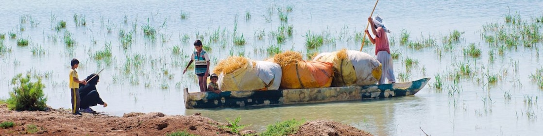 Local people cross the flooded Hawizeh Marshes, near the Majnoon project in Iraq