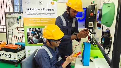 Two students in safety gear conduct experiments in a Shell supported Green Skills EV lab during a Skills4Future vocational training session.