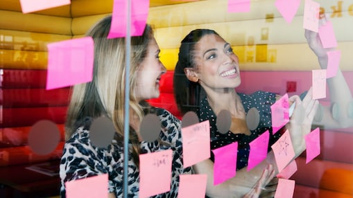 Female workers discussing work in dymanic work environment