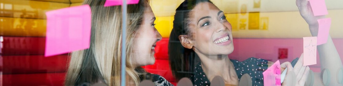 Female workers discussing work in dymanic work environment