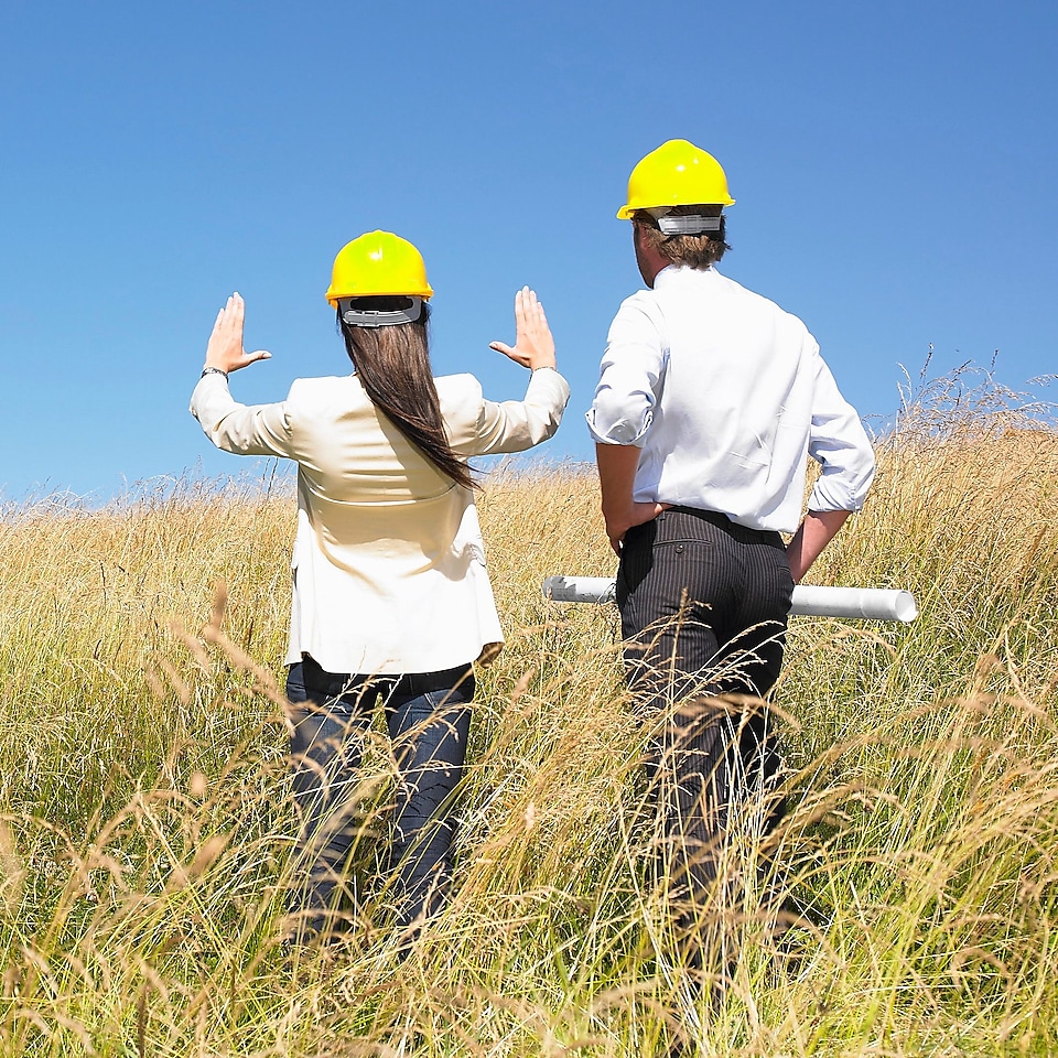 A man and a woman discussing a future construction site