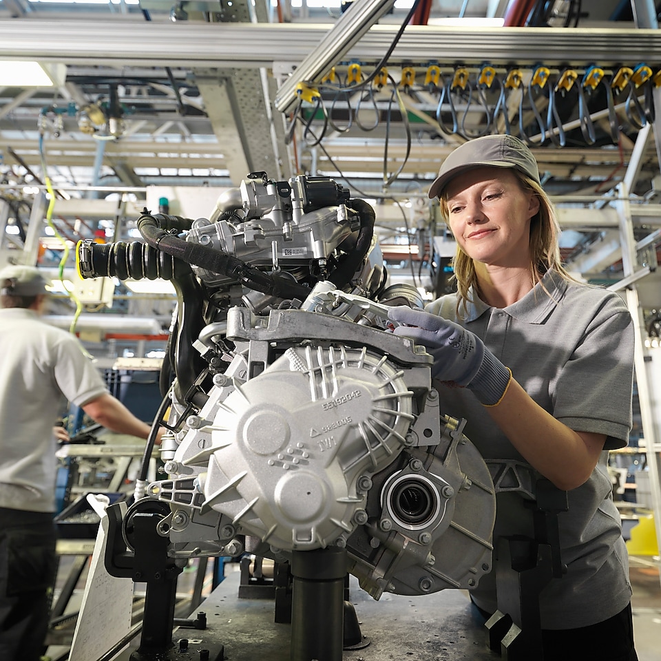 A woman inspecting an engine