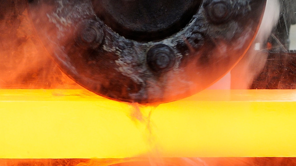 Steel worker mixing melted steel
