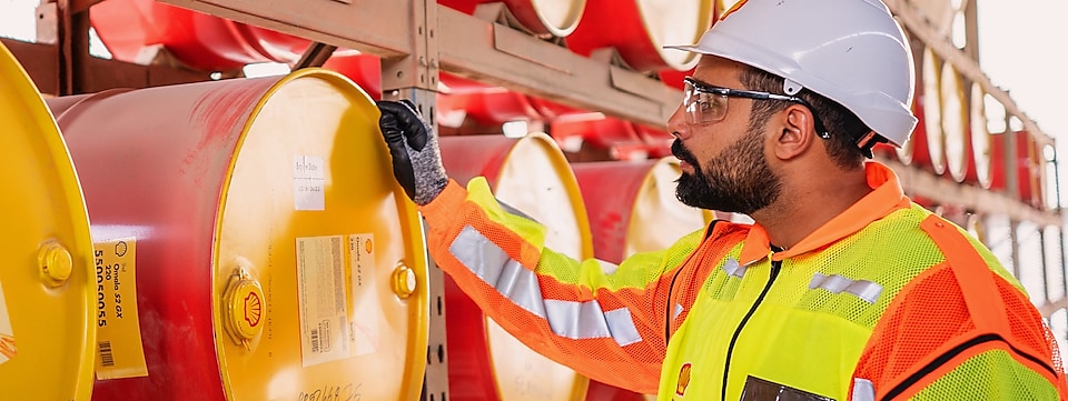 Shell worker inspecting lubricants pails