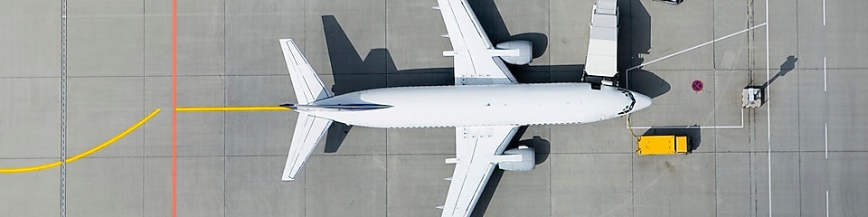 Aerial view of airplane and vans