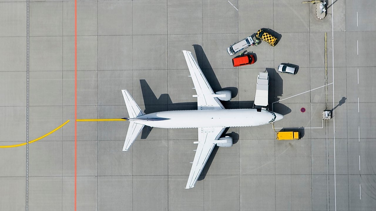 Aerial view of airplane and vans
