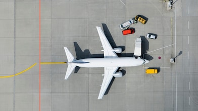 Aerial view of airplane and vans