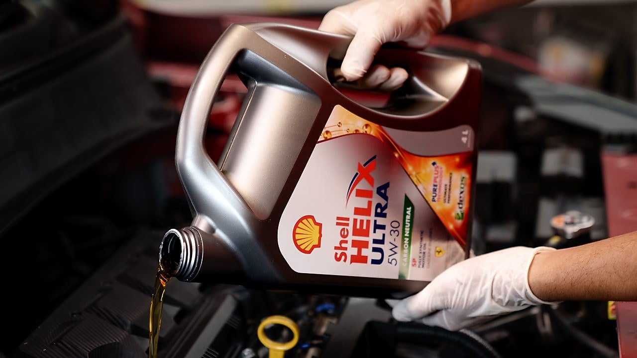 Shell Helix being poured into a car