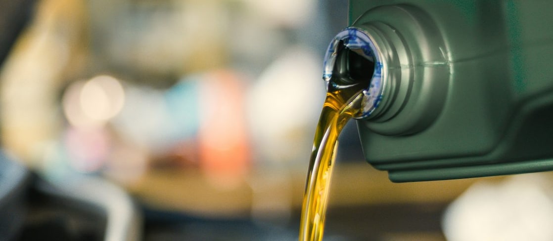 A close up on a lubricant pouring from a bottle