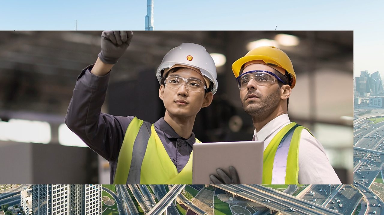 Shell worker consulting an industry worker on site