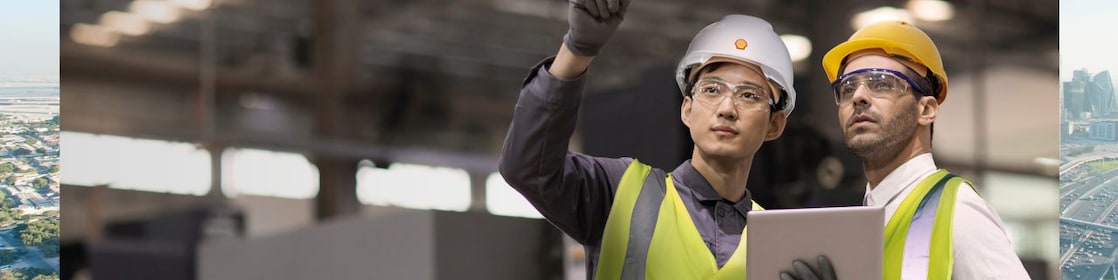 Shell worker consulting an industry worker on site