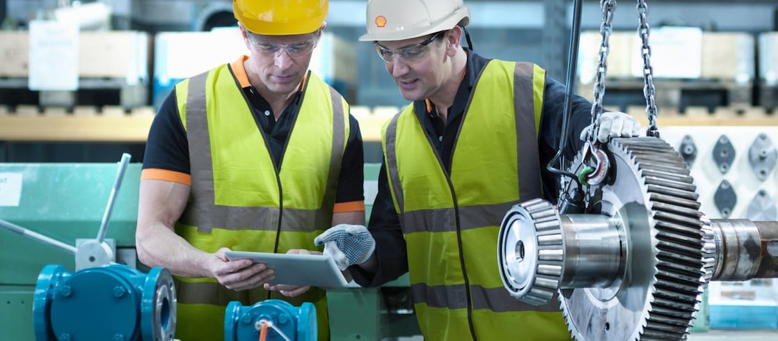 Shell worker consulting an industry worker on site