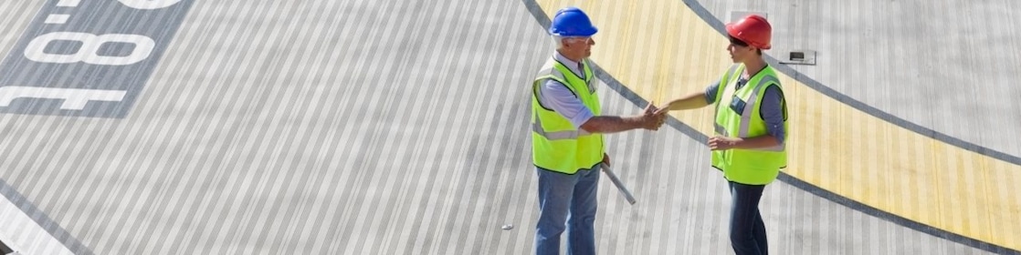 Two Shell employees shake hands as part of a partnership