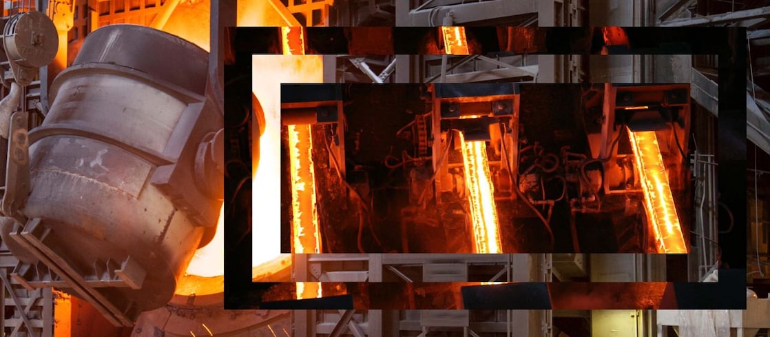 Workers in hard hats in a metal factory