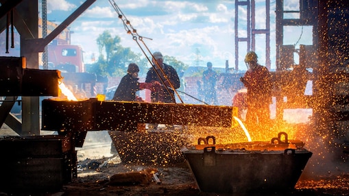 Liquid metal being poured with lots of fire sparks