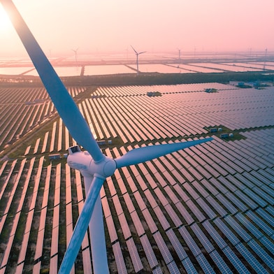 Windmill surrounded by solar panels