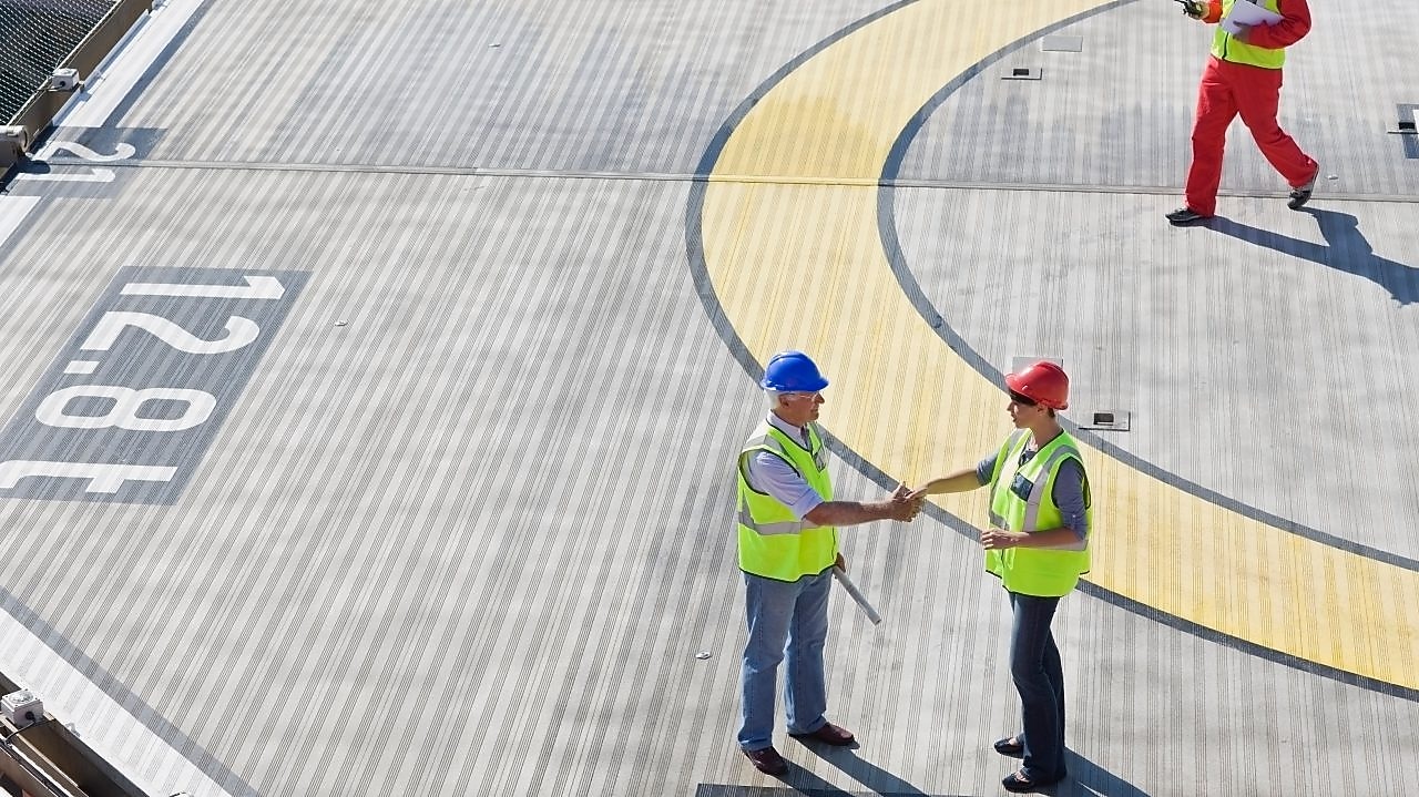 Two Shell employees shake hands as part of a partnership