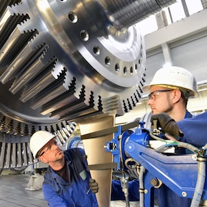Two engineers working on a turbine