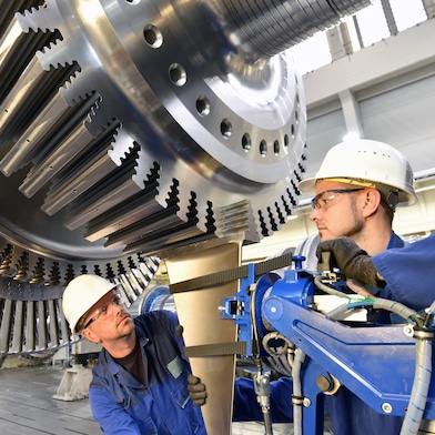Two engineers working on a turbine