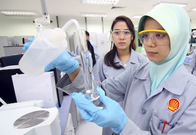 Lab technicians working in the Production Chemistry Lab in Sarawak Lutong Office, Miri.