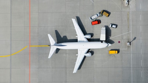 Aerial view of airplane and vans