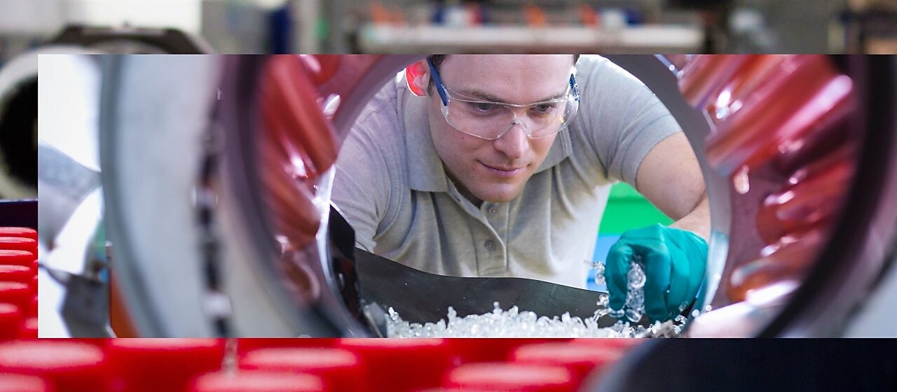 Factory worker with plastics manufacturing equipment