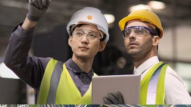 Shell worker consulting an industry worker on site