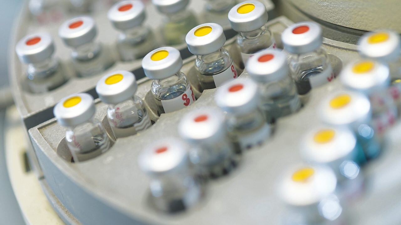 Vials of samples on an auto sampler
