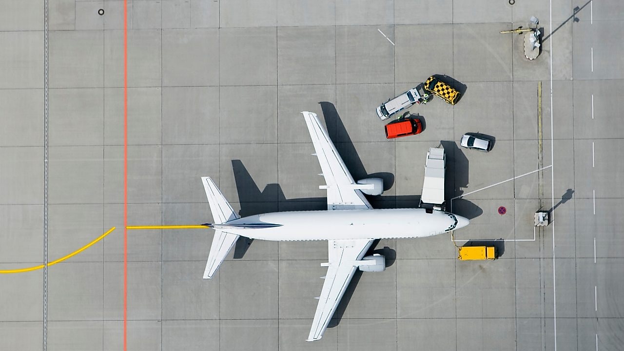 Aerial view of airplane and vans