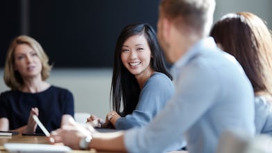 Smiling businesswoman in meeting.