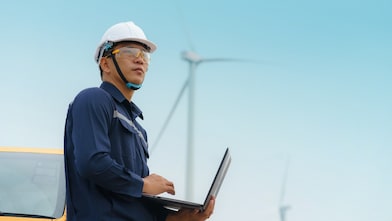 Asian man working on a wind turbine project.