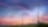 Two wind turbines with pink, purple and blue sunset background.