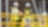 Two Shell emplyees wearing hardhats and yellow reflective jacket interacting in warehouse environment.
