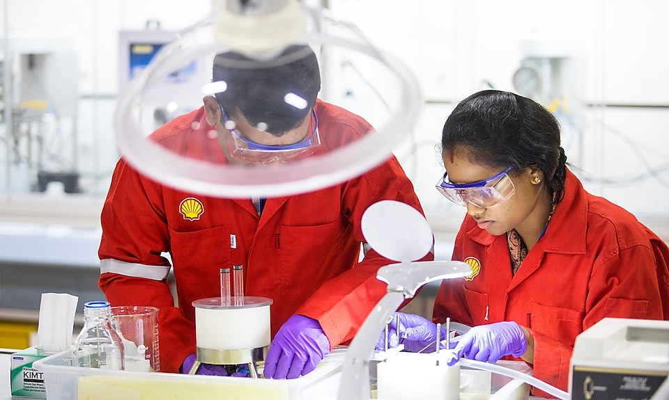 A woman Shell employee working with a man in a laboratory