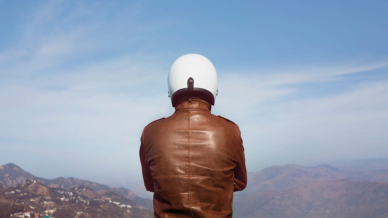 person in brown jacket and white helmet