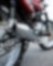 motorcycle parked on road with camera focused on the exhaust and wheels