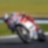 ducati superbike with rider cornering at speed on a racetrack